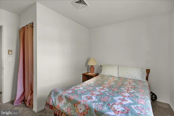 a bedroom with a bed and a night stand