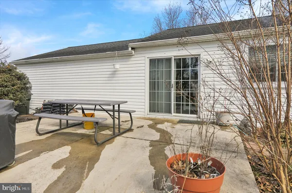 a view of a chairs and table in the back yard of the house
