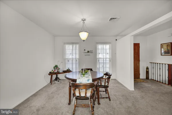 a view of a dining room with furniture and window