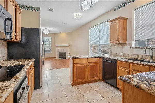 a kitchen with stainless steel appliances granite countertop a stove sink and cabinets