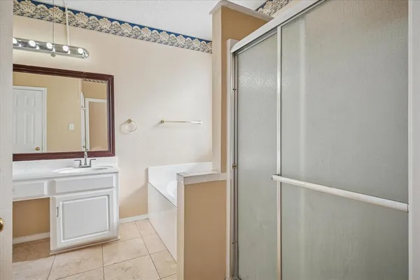 a bathroom with a sink a mirror and a shower