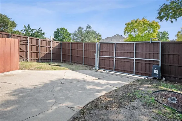 a view of a backyard with wooden fence