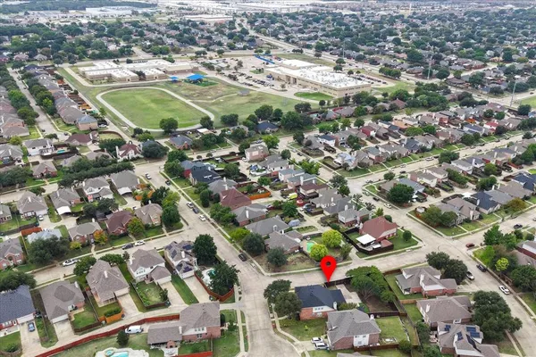 an aerial view of residential houses with outdoor space