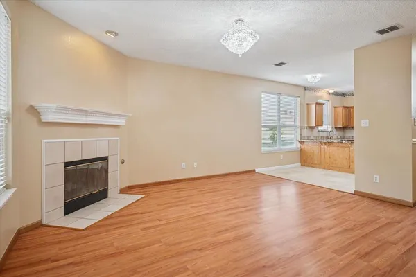 a view of a kitchen with a sink a refrigerator and a fireplace