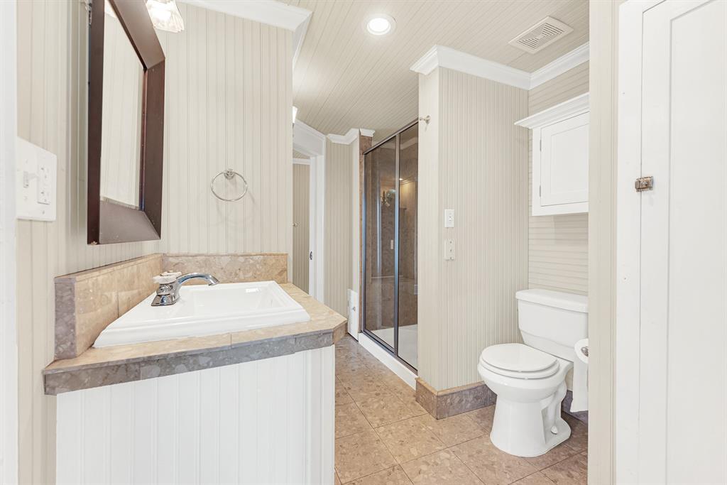 1425 Lone Star Road Celina, TX 75009 - Photo 19 of 40 Natural stone countertops and a spacious layout create a bathroom that's both timeless and designed for everyday convenience. The Jack-and-Jill arrangement gives adjoining bedrooms easy access while providing comfort and privacy for family or overnight guests.