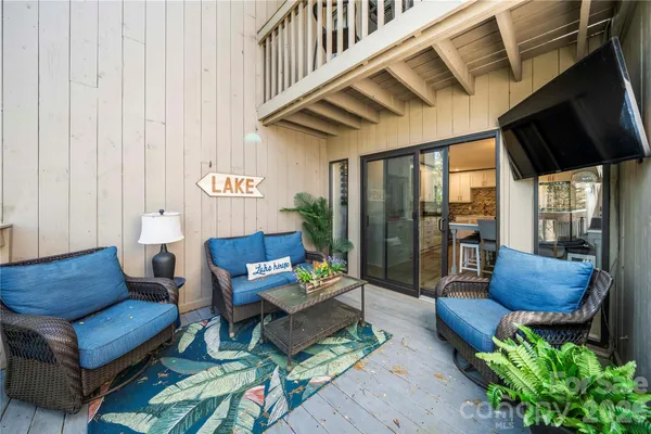 a living room with furniture and a floor to ceiling window