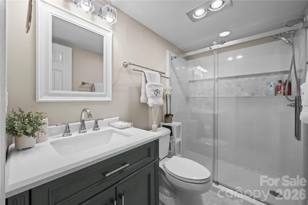 a bathroom with a sink toilet and shower