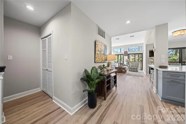 a living room with furniture and a potted plant
