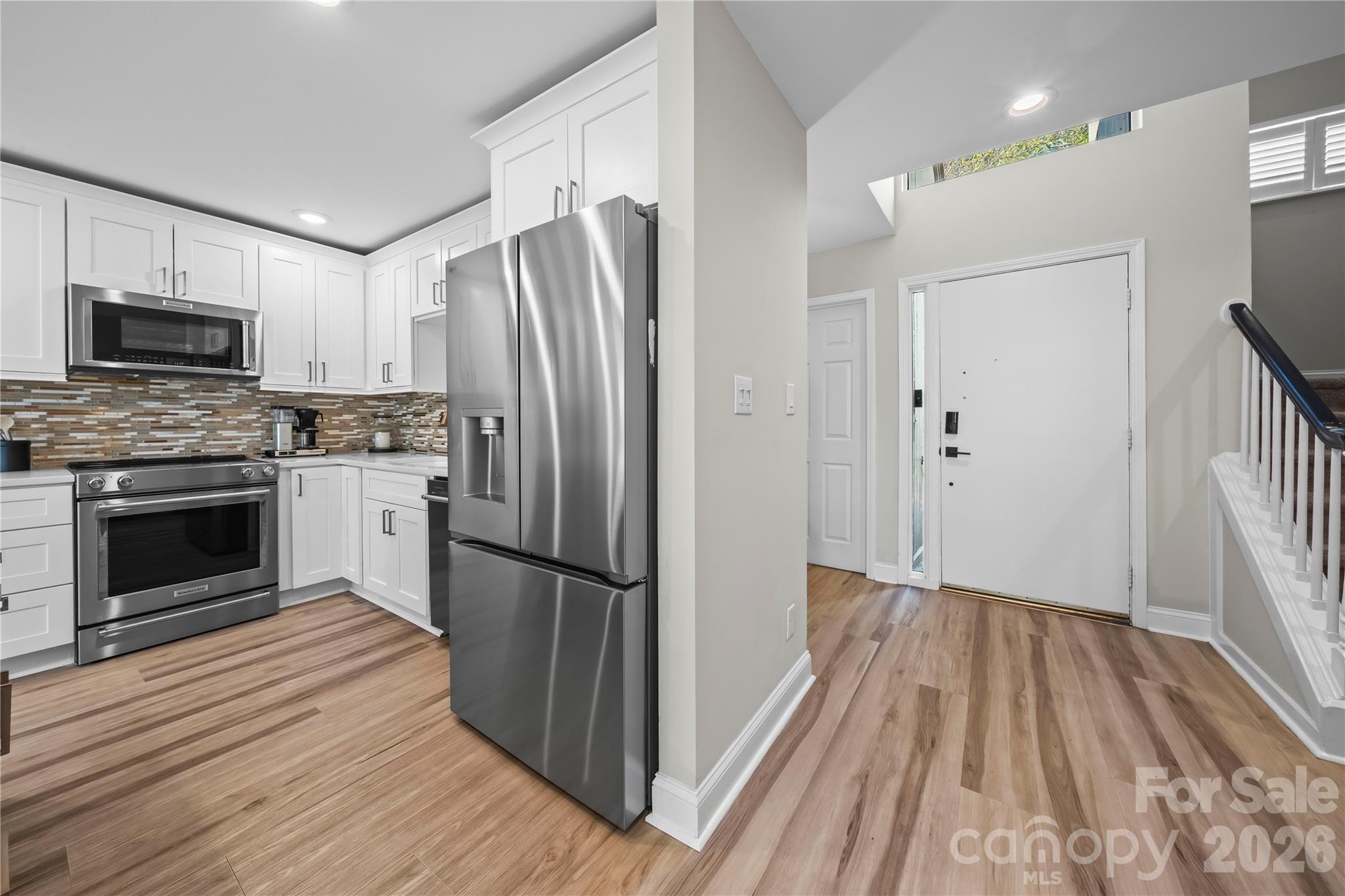 133 Pine Grove Circle Clover, SC 29710 - Photo 19 of 48 a kitchen with wooden floors a sink appliances and cabinets