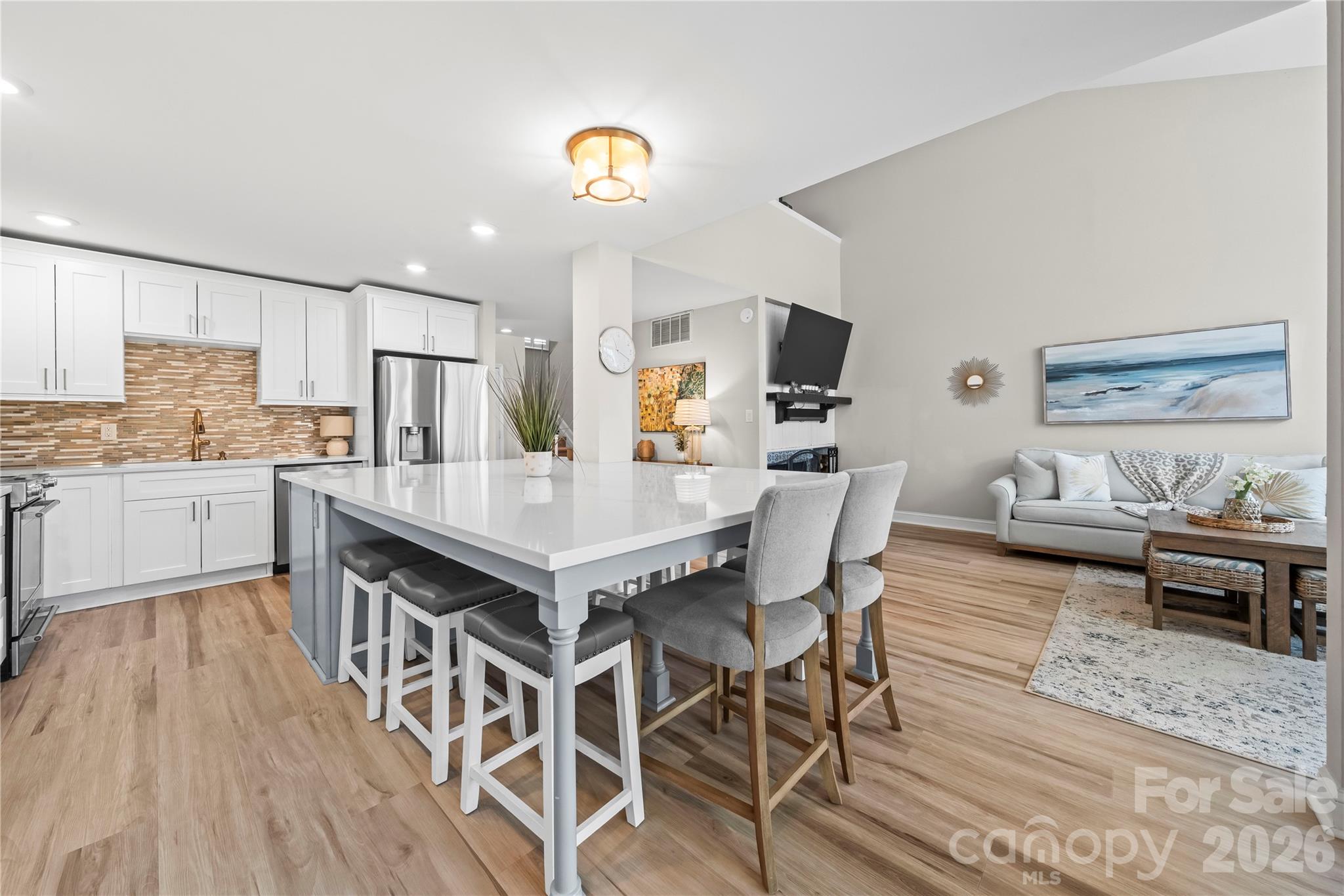 133 Pine Grove Circle Clover, SC 29710 - Photo 23 of 48 a kitchen with stainless steel appliances a dining table chairs and wooden floor