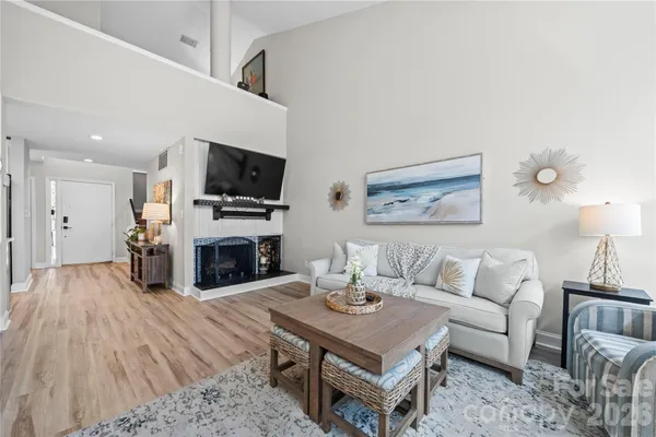 a living room with furniture a fireplace and a flat screen tv