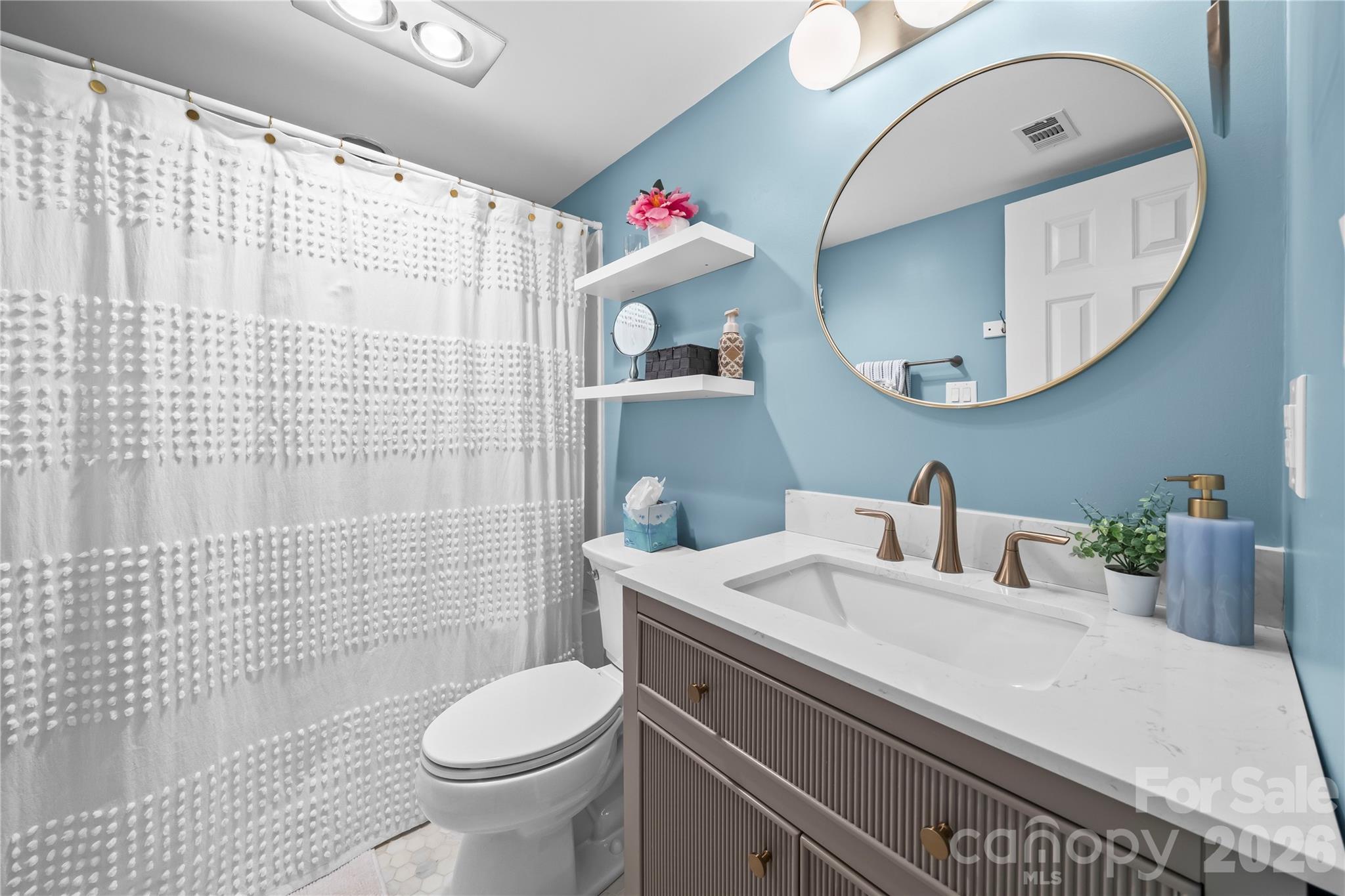 133 Pine Grove Circle Clover, SC 29710 - Photo 38 of 48 a bathroom with a sink a toilet and a mirror
