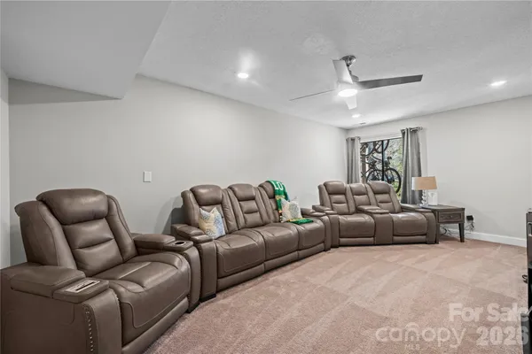a living room with furniture and a ceiling fan