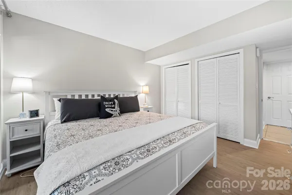 a bedroom with a bed and a night stand
