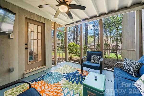 a living room with furniture and a floor to ceiling window