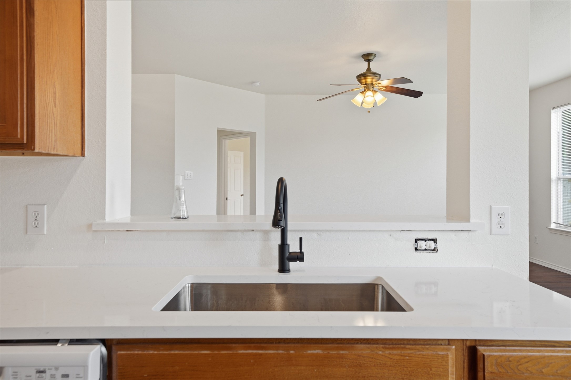 118 Invierno Street Kyle, TX 78640 - Photo 12 of 37 A well-appointed kitchen offers ample counter space and a convenient pass-through to the adjacent living area.