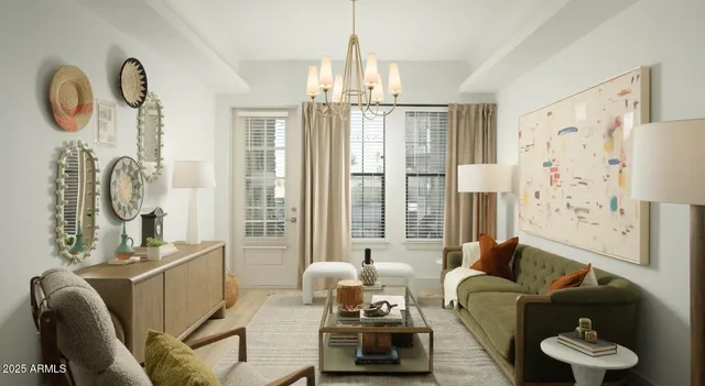 a living room with furniture a chandelier and a large window