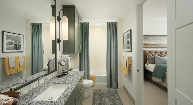 a bathroom with a granite countertop sink a mirror and a shower
