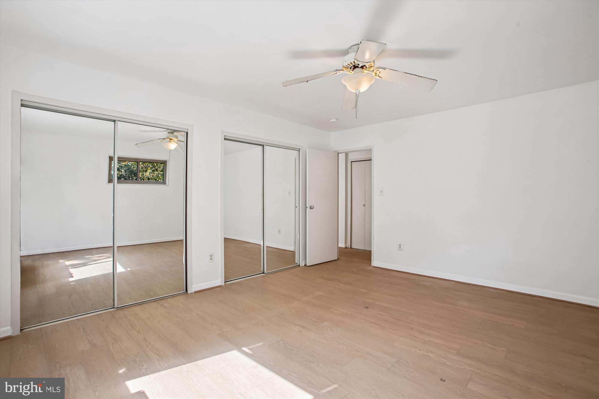 3900 Tunlaw Road Northwest, Unit 509 Washington, DC 20007 - Photo 11 of 19 a view of an empty room with a ceiling fan and window
