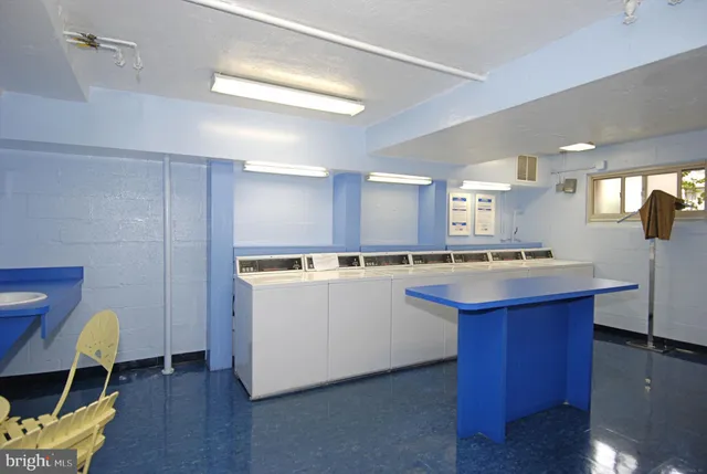 a kitchen with kitchen island a sink cabinets and wooden floor