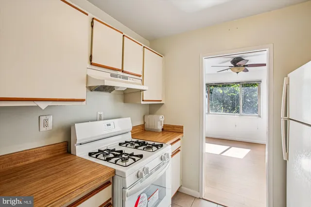 a kitchen with stainless steel appliances granite countertop a stove a refrigerator and a microwave