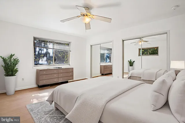 a bedroom with a bed dresser and a window