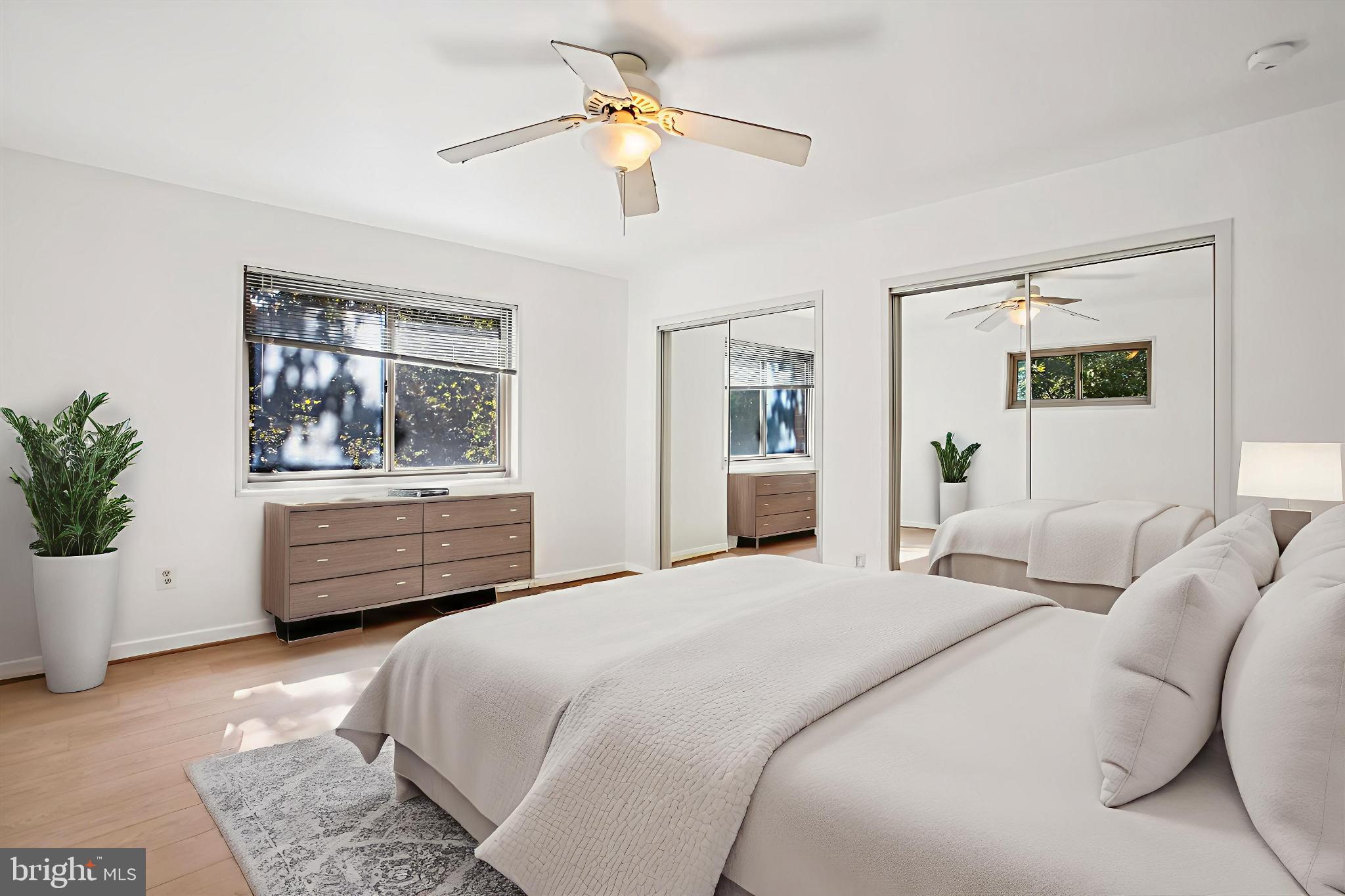 3900 Tunlaw Road Northwest, Unit 509 Washington, DC 20007 - Photo 8 of 19 a bedroom with a bed dresser and a window