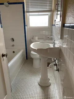 a bathroom with a sink a toilet and bathtub