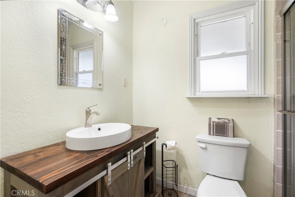4669 Edgewood Place Riverside, CA 92506 - Photo 13 of 26 a bathroom with a sink toilet and mirror