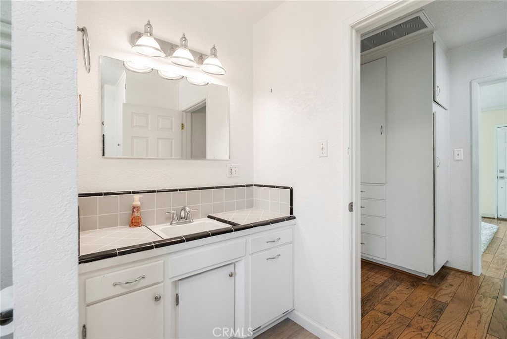4669 Edgewood Place Riverside, CA 92506 - Photo 17 of 26 a bathroom with a sink and a mirror