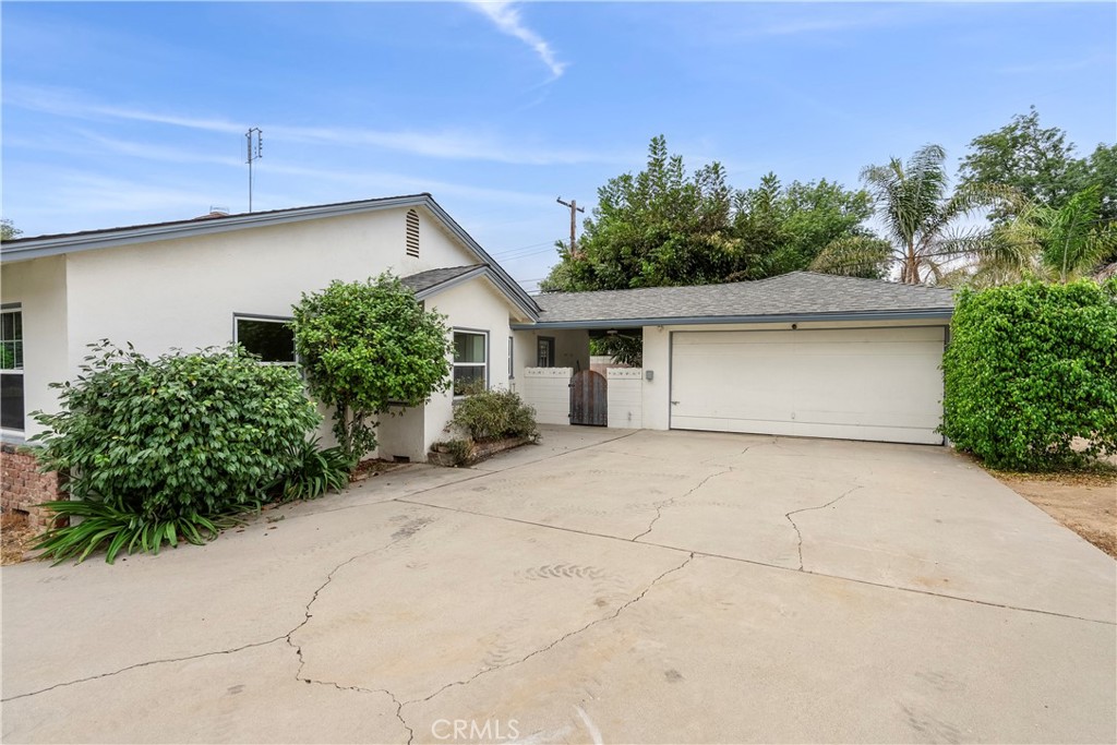 4669 Edgewood Place Riverside, CA 92506 - Photo 2 of 26 a front view of a house with garden