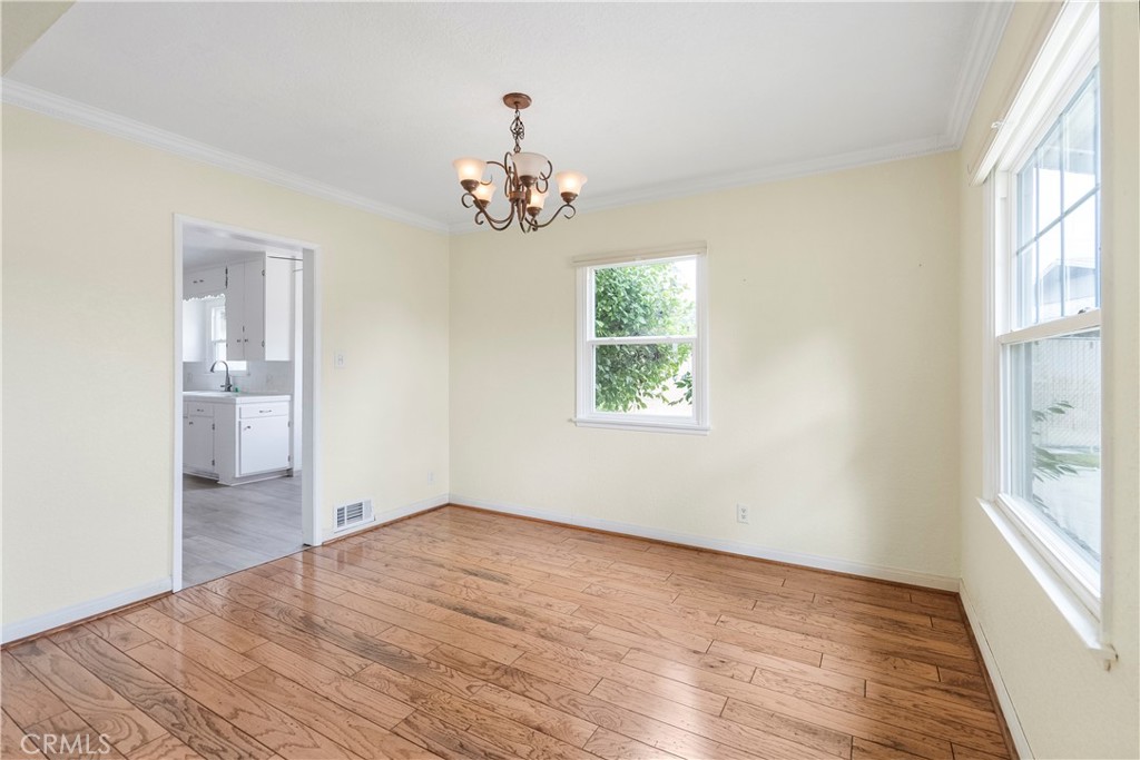 4669 Edgewood Place Riverside, CA 92506 - Photo 4 of 26 an empty room with wooden floor and windows