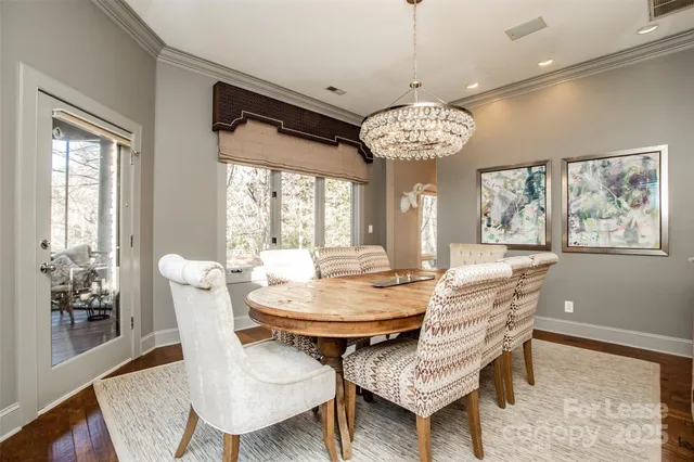 a view of a dining room with furniture wooden floor and chandelier