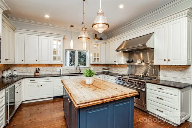 a kitchen with granite countertop cabinets stainless steel appliances and a window
