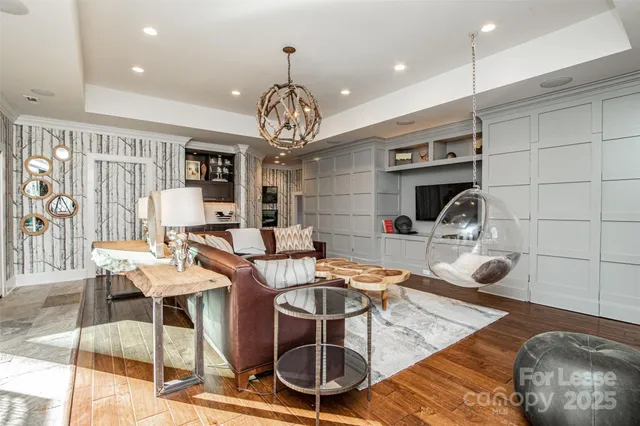 a room with gym equipment and view of kitchen