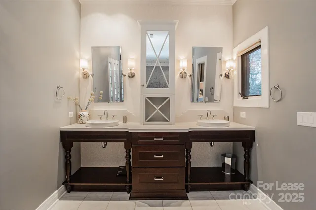 a bathroom with a sink a double vanity and a mirror