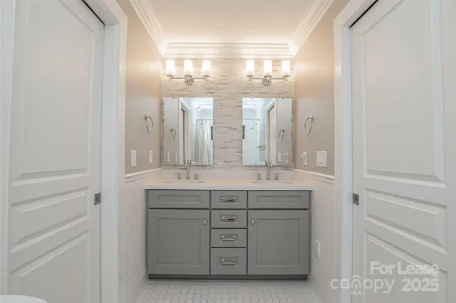 a bathroom with a double vanity sink and a mirror