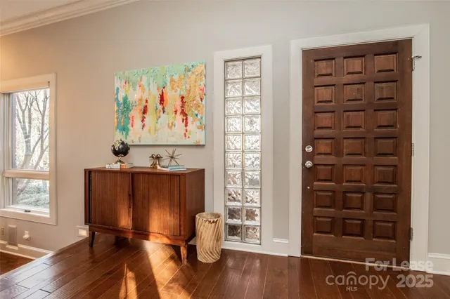 a view of room with window and wooden floor