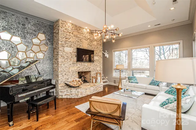 a living room with fireplace furniture and a chandelier