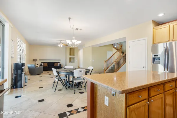 a living room with furniture a chandelier and a dining table