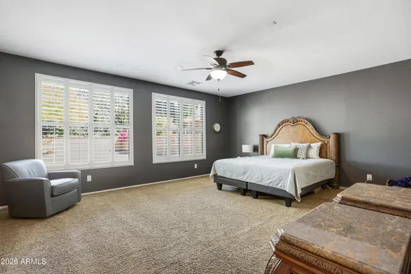 a bedroom with a bed couch and window