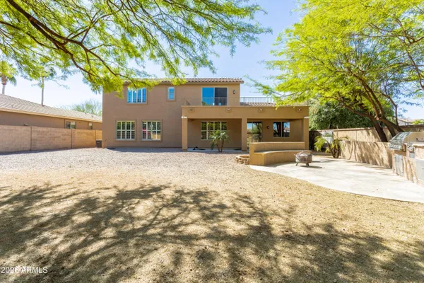 a front view of a house with a yard and trees