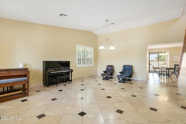 a room with furniture a dining table and a piano table