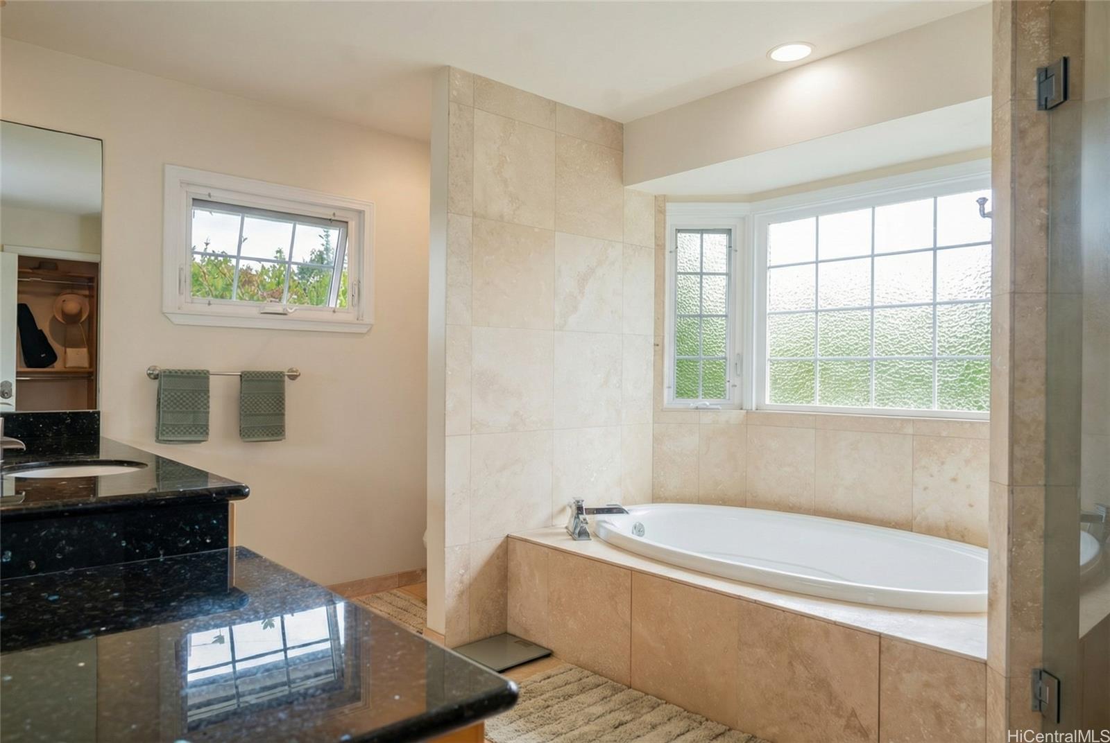 4026 Harding Avenue Honolulu, HI 96816 - Photo 14 of 18 a bathroom with a bathtub and a window