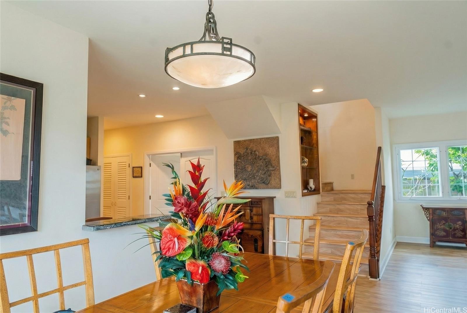 4026 Harding Avenue Honolulu, HI 96816 - Photo 15 of 18 a view of a dining room with furniture a potted plant and wooden floor
