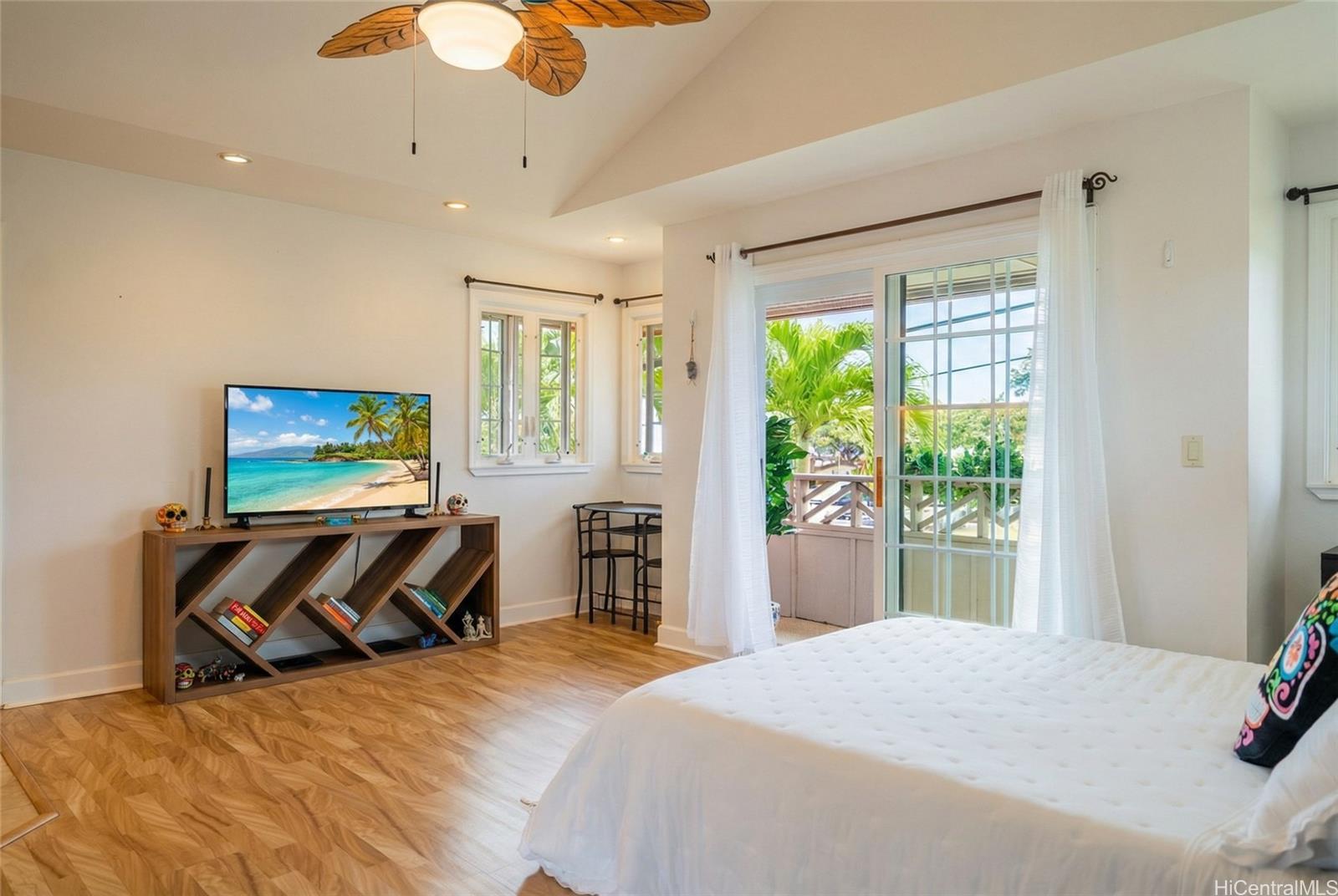 4026 Harding Avenue Honolulu, HI 96816 - Photo 10 of 18 a bedroom with a bed and glass windows