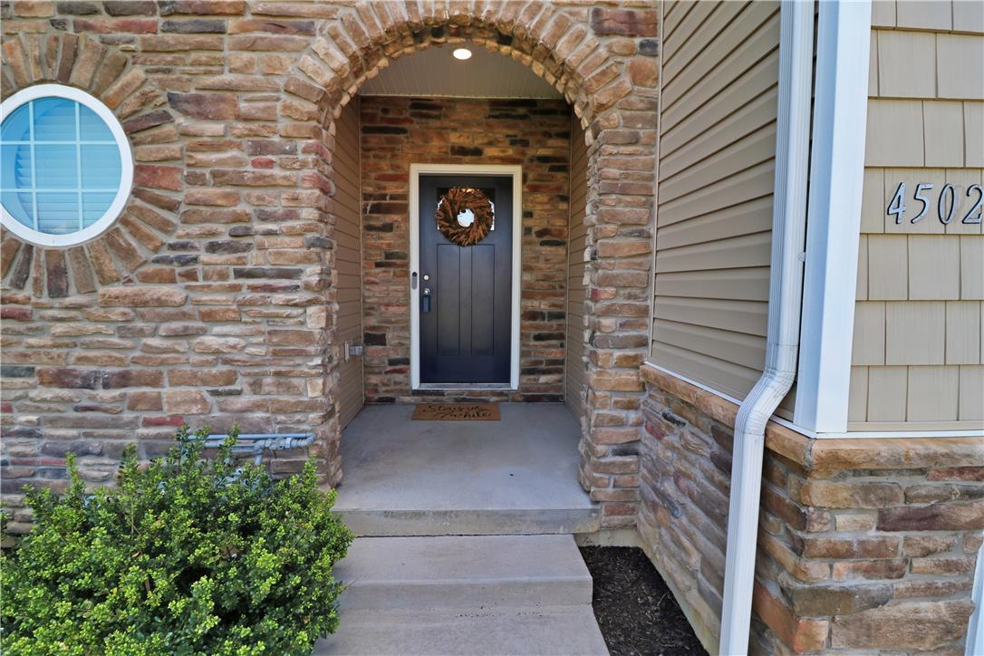 4502 Benjamin Court Emmaus, PA 18049 - Photo 3 of 53 A welcoming arched stone entrance, complemented by a distinctive round window and hardy siding.