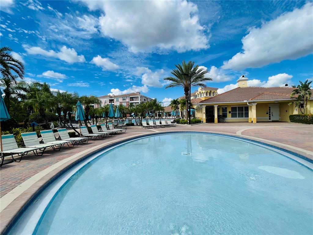 5049 Shoreway Loop, Unit 40601 Orlando, FL 32819 - Photo 24 of 28 a view of swimming pool with outdoor seating and a pathway