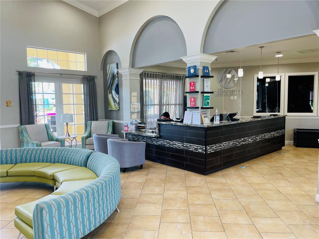 5049 Shoreway Loop, Unit 40601 Orlando, FL 32819 - Photo 27 of 28 a living room with furniture and a chandelier