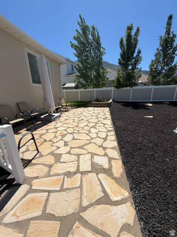 118 Tram Rock Rd. Lake Point, UT 84074 - Photo 31 of 34 Expansive rear patio featuring flagstone paving
